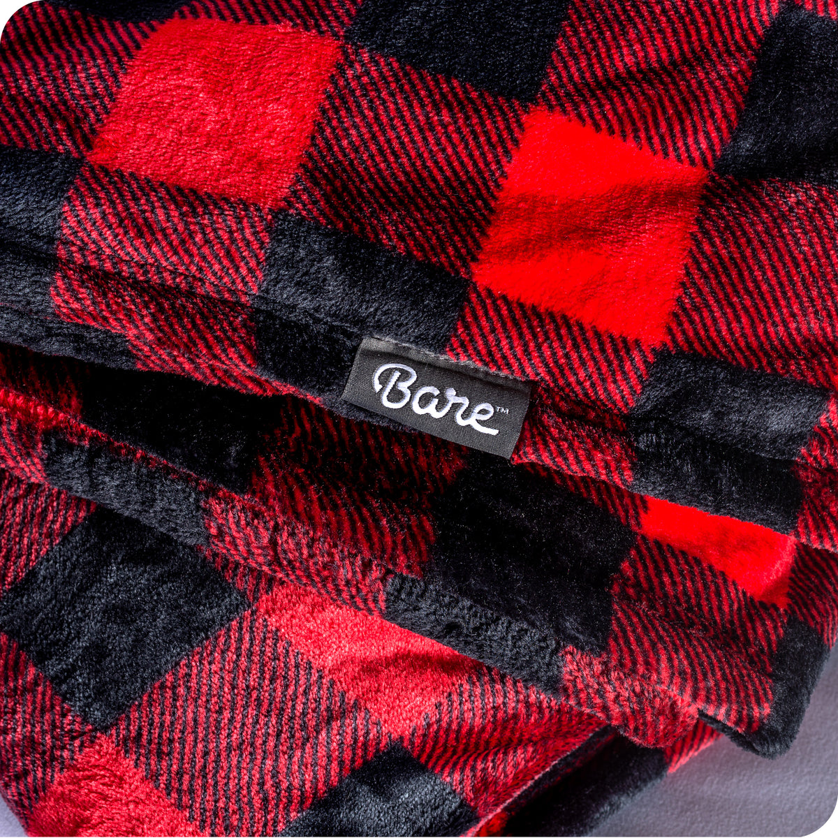 Red and black plaid blanket with a 'Bare' brand label.