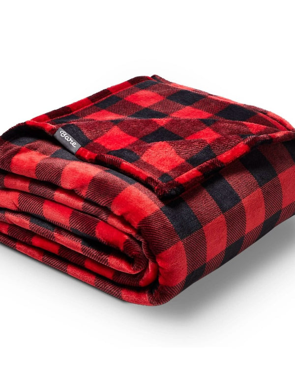 Microplush blanket laid out over a bed
