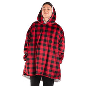 An adult with a hooded wearable blanket on