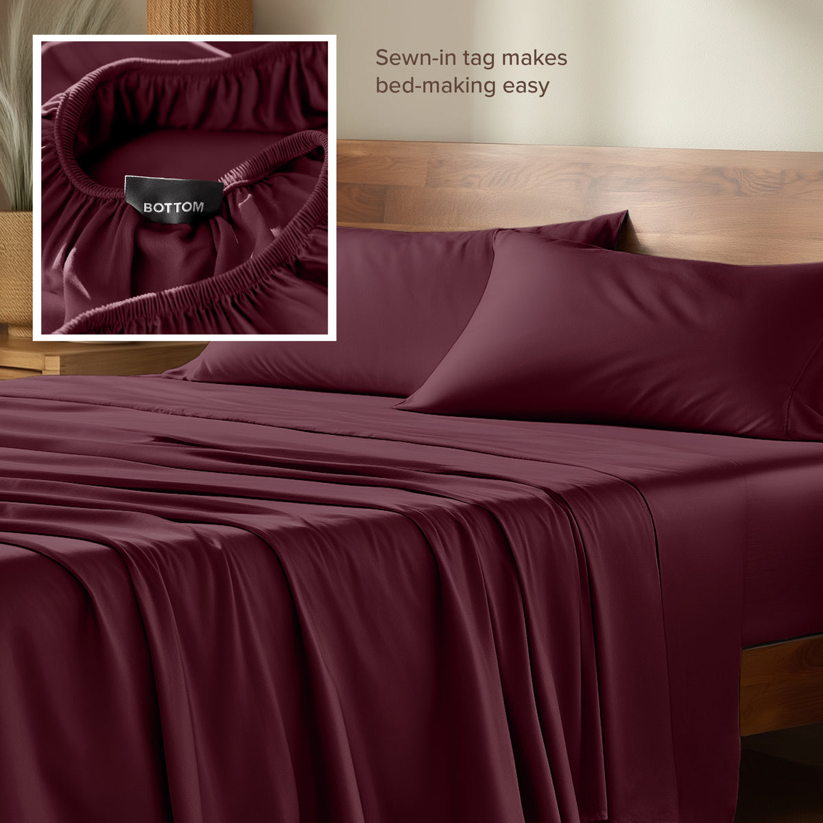 Bamboo sheets with a sewn-in tag on a wooden bed frame.