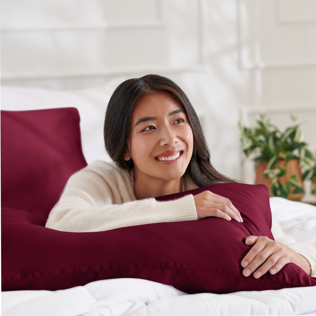 Woman lying on abed with a silk pillowcase
