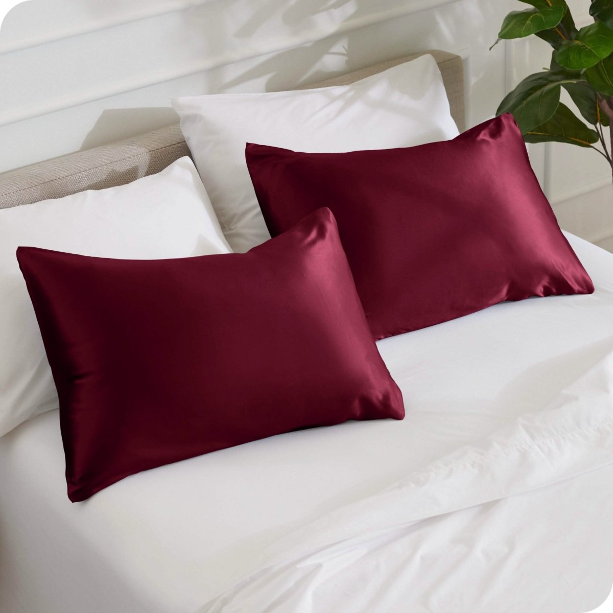 2 mulberry silk pillowcases on pillows set on a bed
