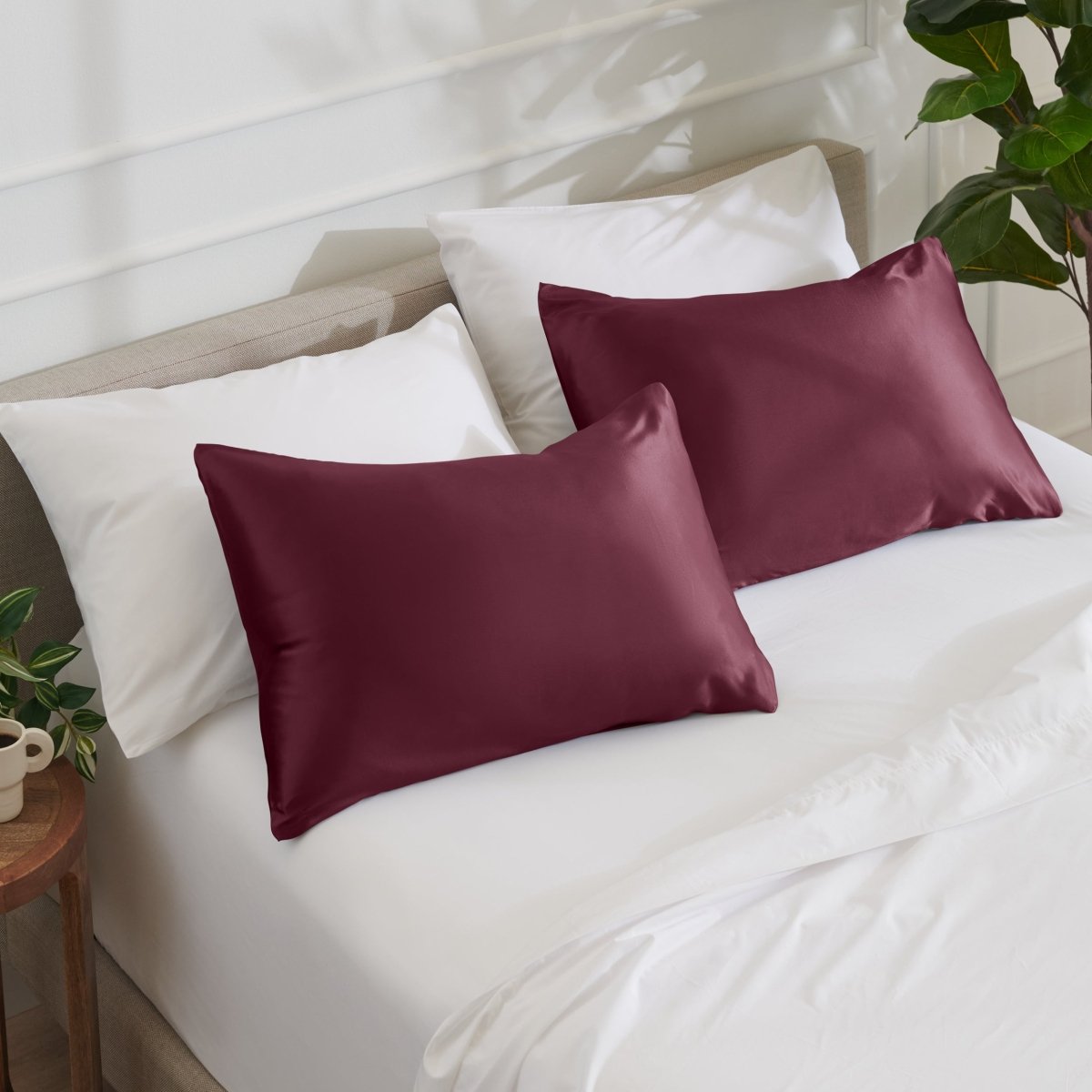 Satin pillowcases on a bed with white bedding