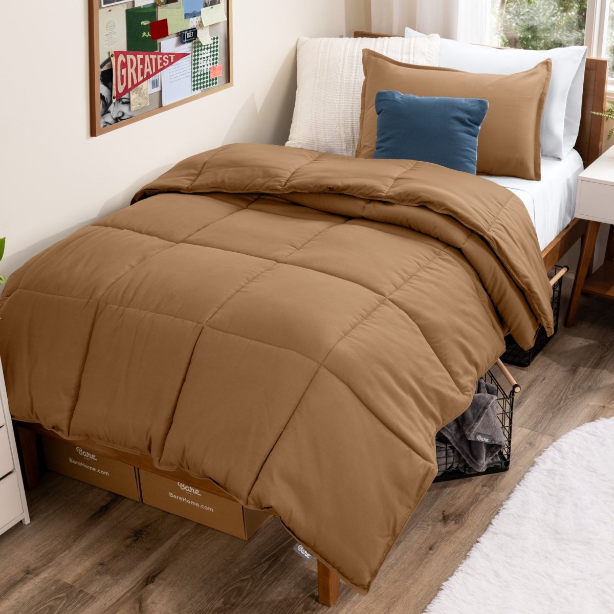 Bed with comforter and pillows in a dorm room