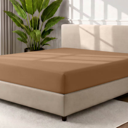 Ultra soft fitted sheet on a mattress with the sun shining into the bedroom
