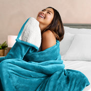 A woman smiling while wrapped in a sherpa blanket