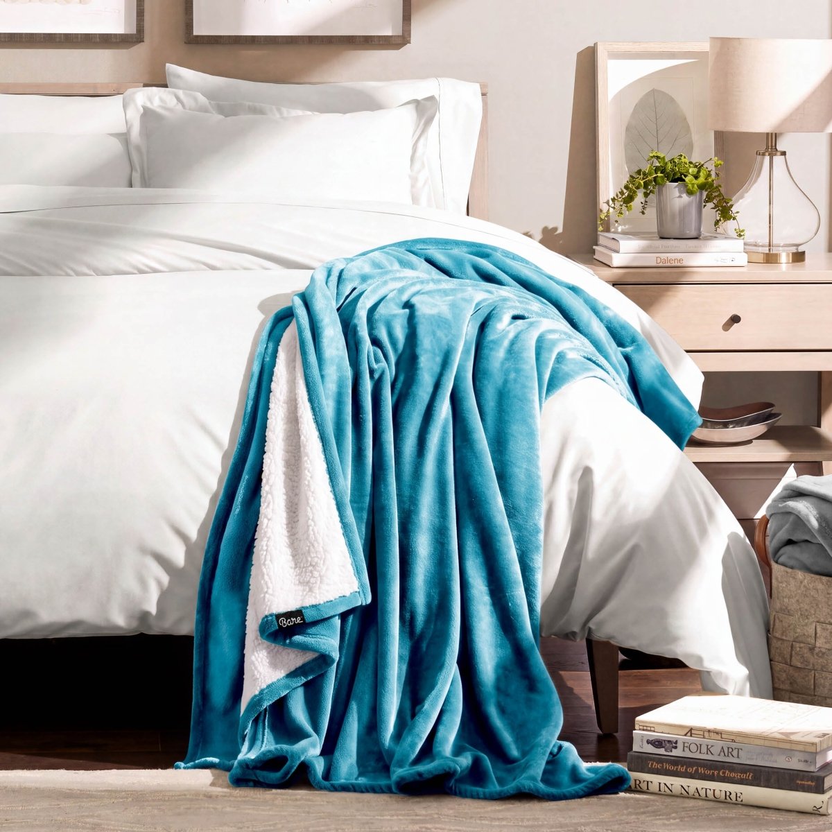 A sherpa blanket draped over the corner of a bed