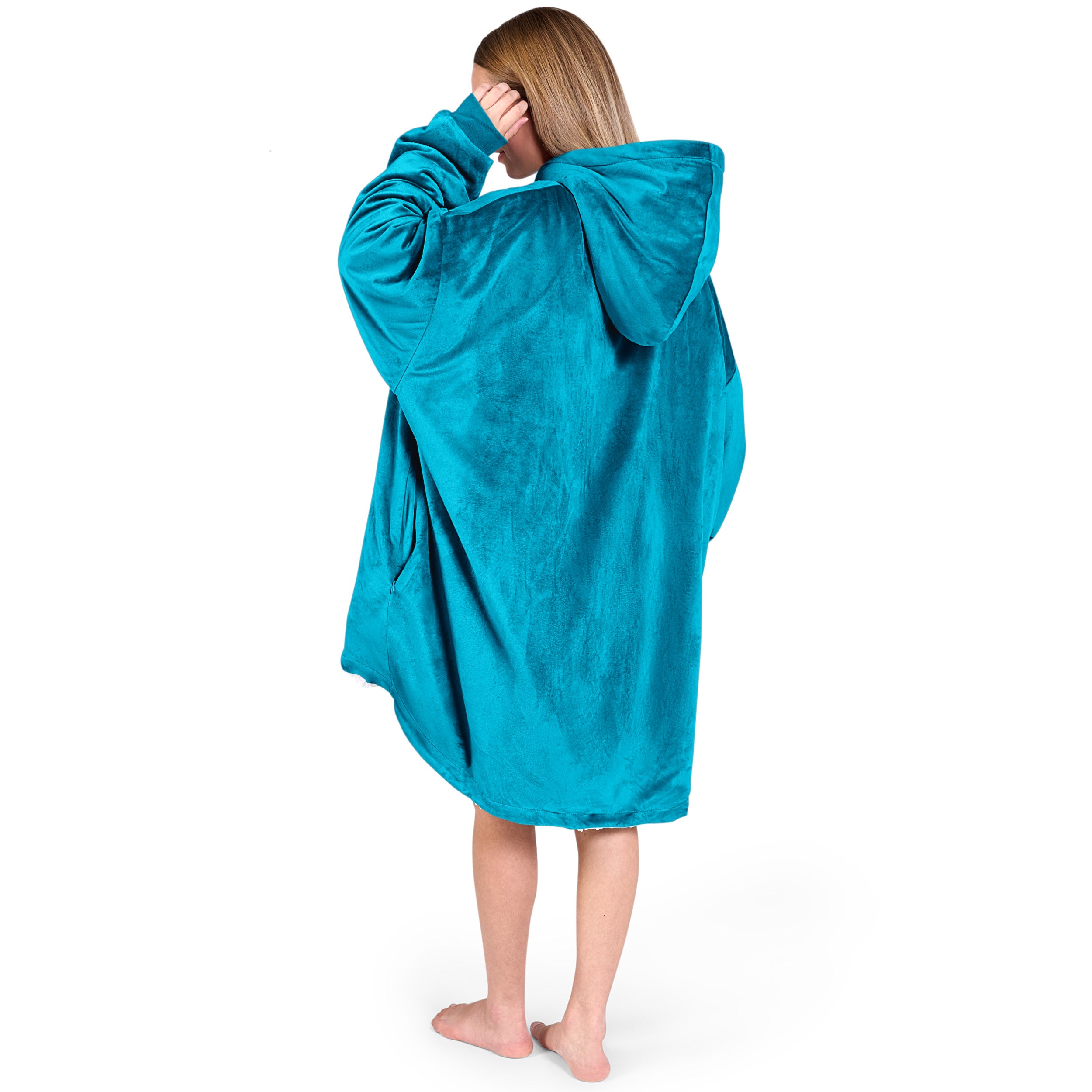 An adult with a hooded wearable blanket on