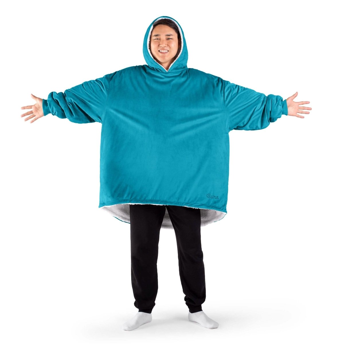 An adult with a sherpa wearable blanket on