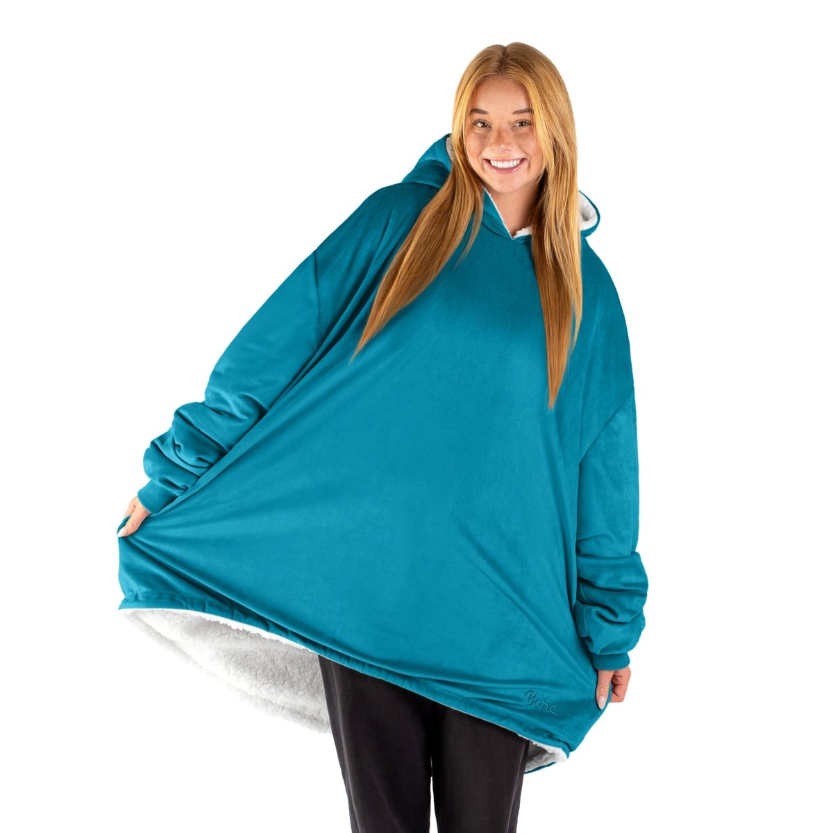 An adult with a sherpa wearable blanket on