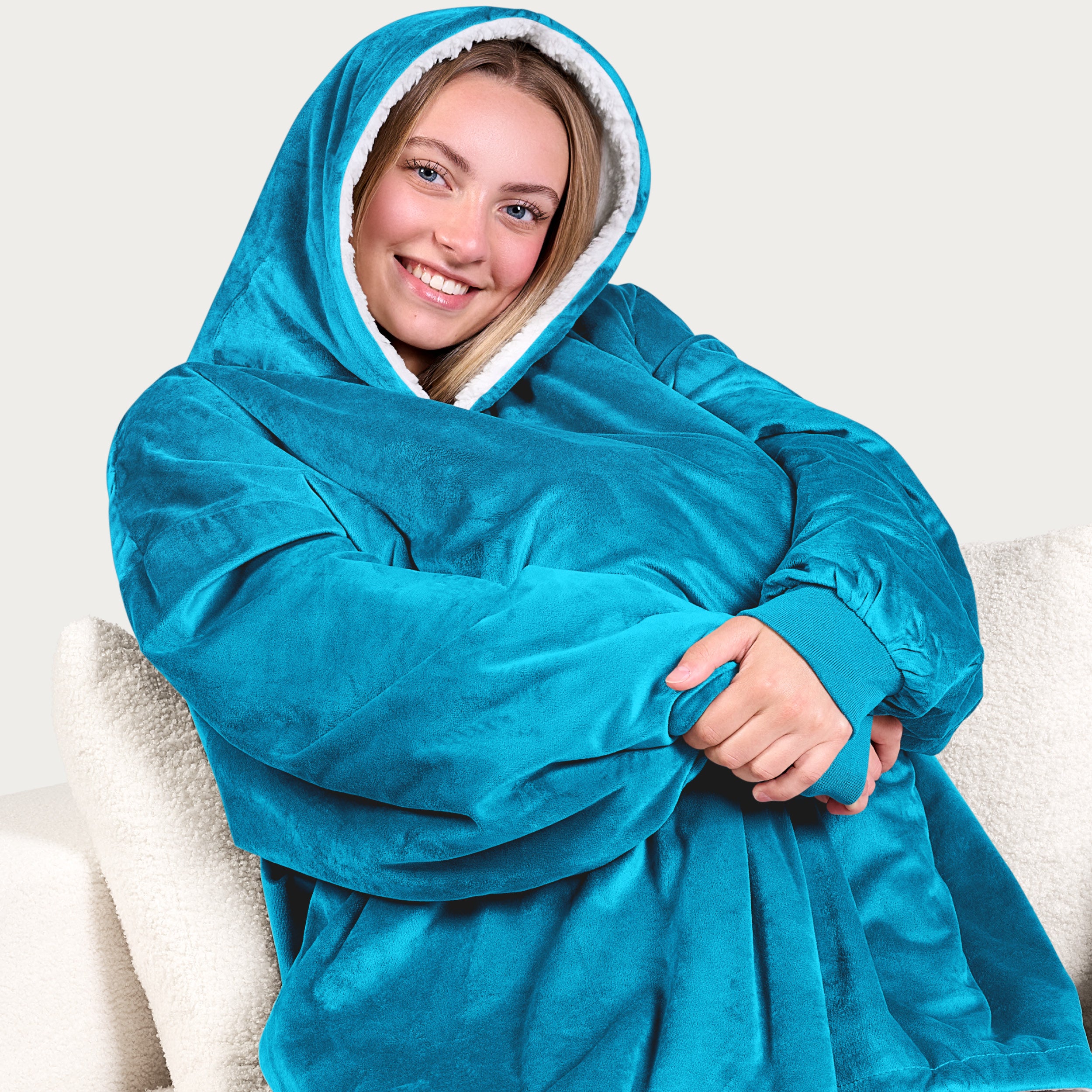 An adult with a sherpa wearable blanket on