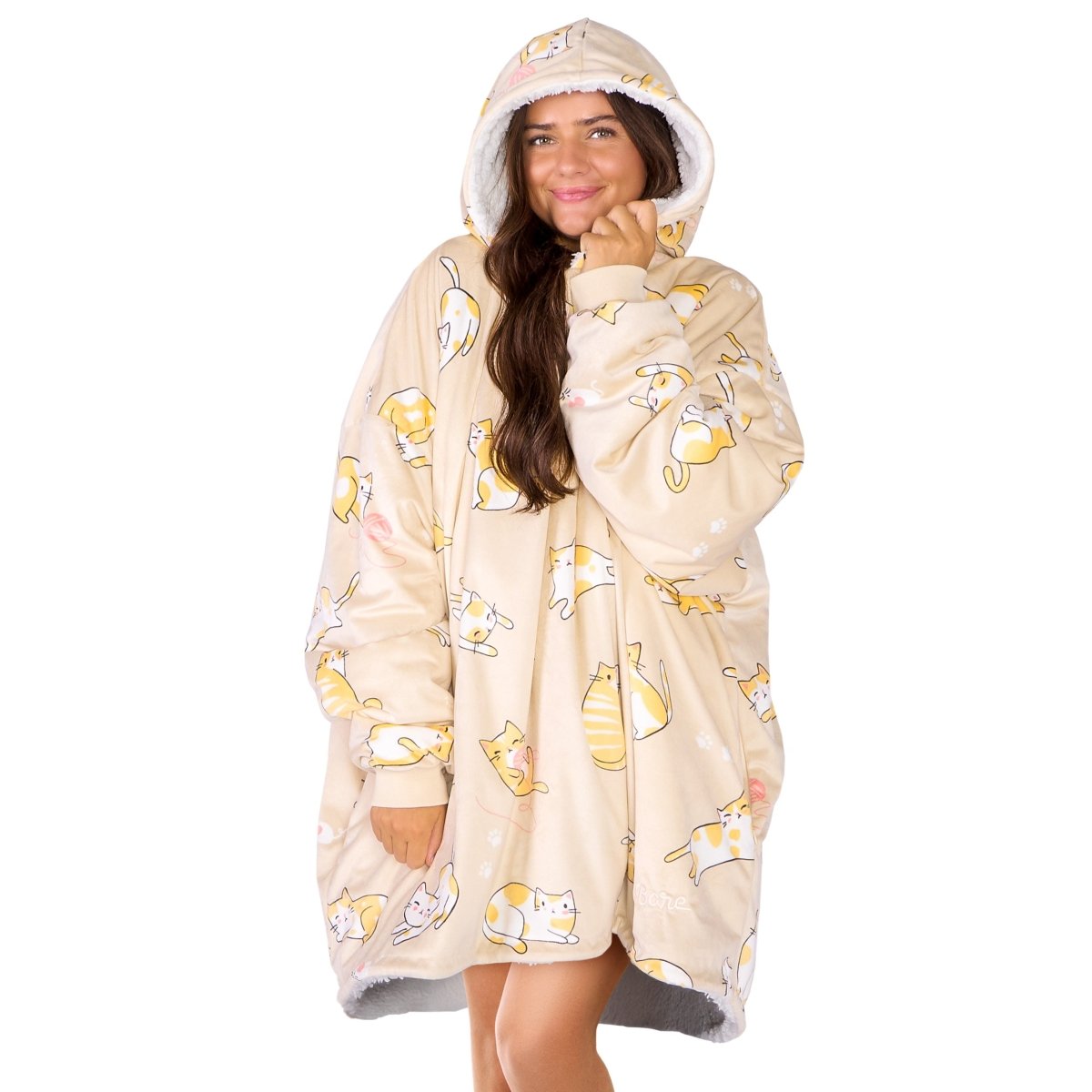 An adult with a sherpa wearable blanket on
