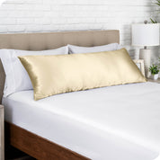 A silk body pillowcase on a pillow resting on a headboard