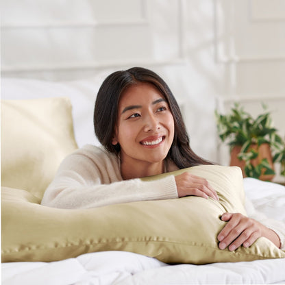 Woman lying on abed with a silk pillowcase