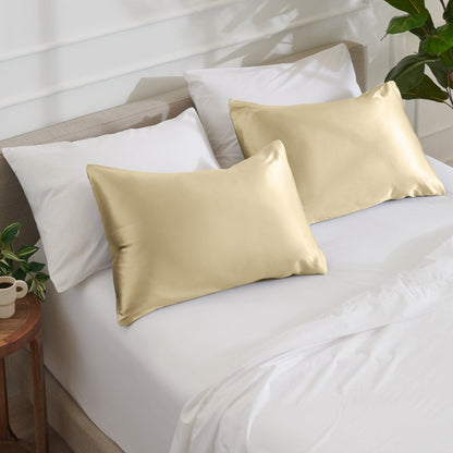 Satin pillowcases on a bed with white bedding