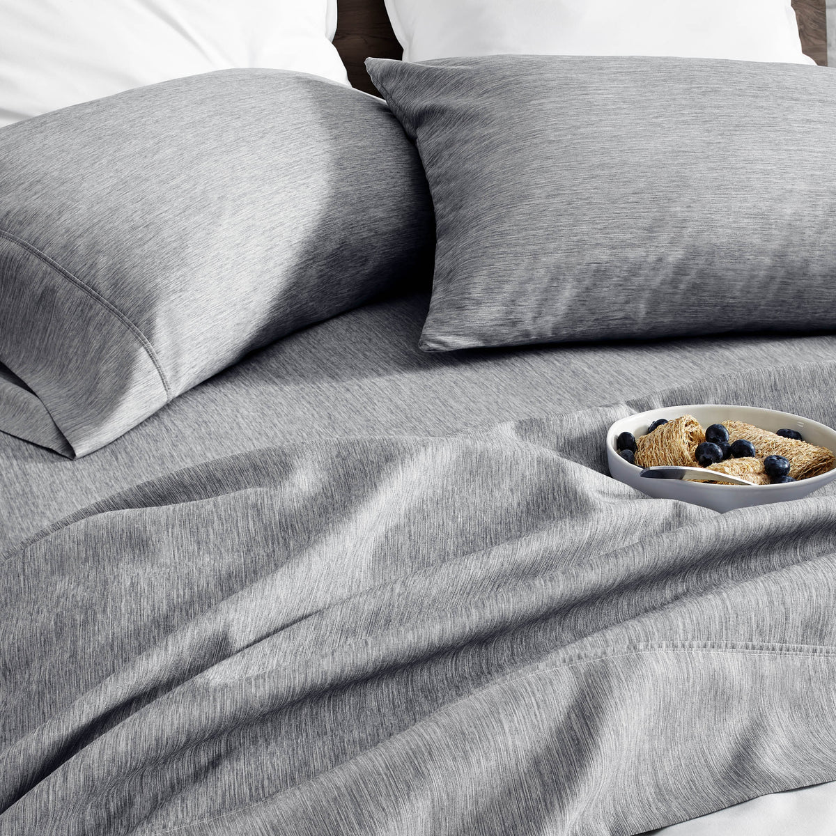 Ultra soft sheet set with a bowl of food on a bed