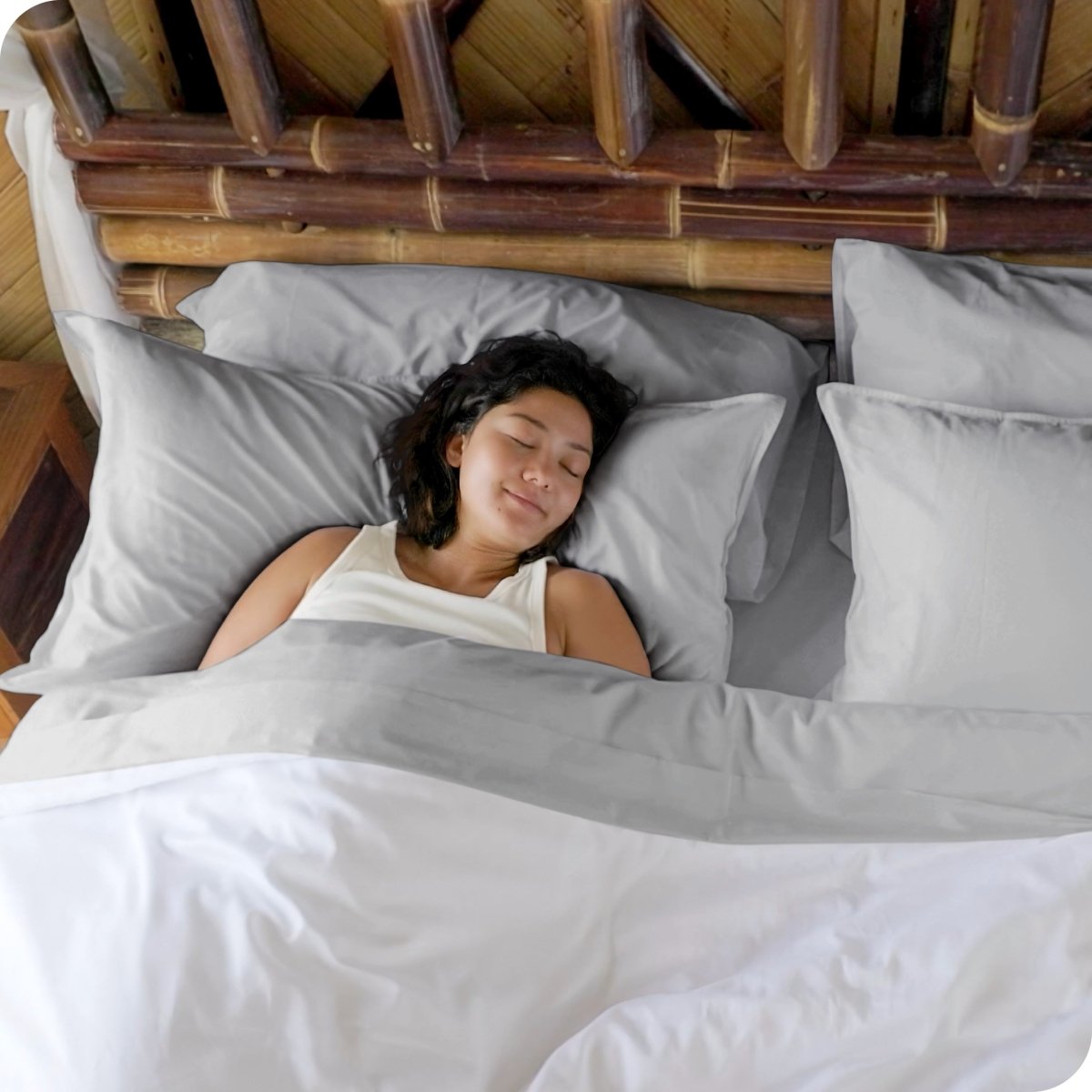 A woman sleeping in a bed made with bamboo sheets