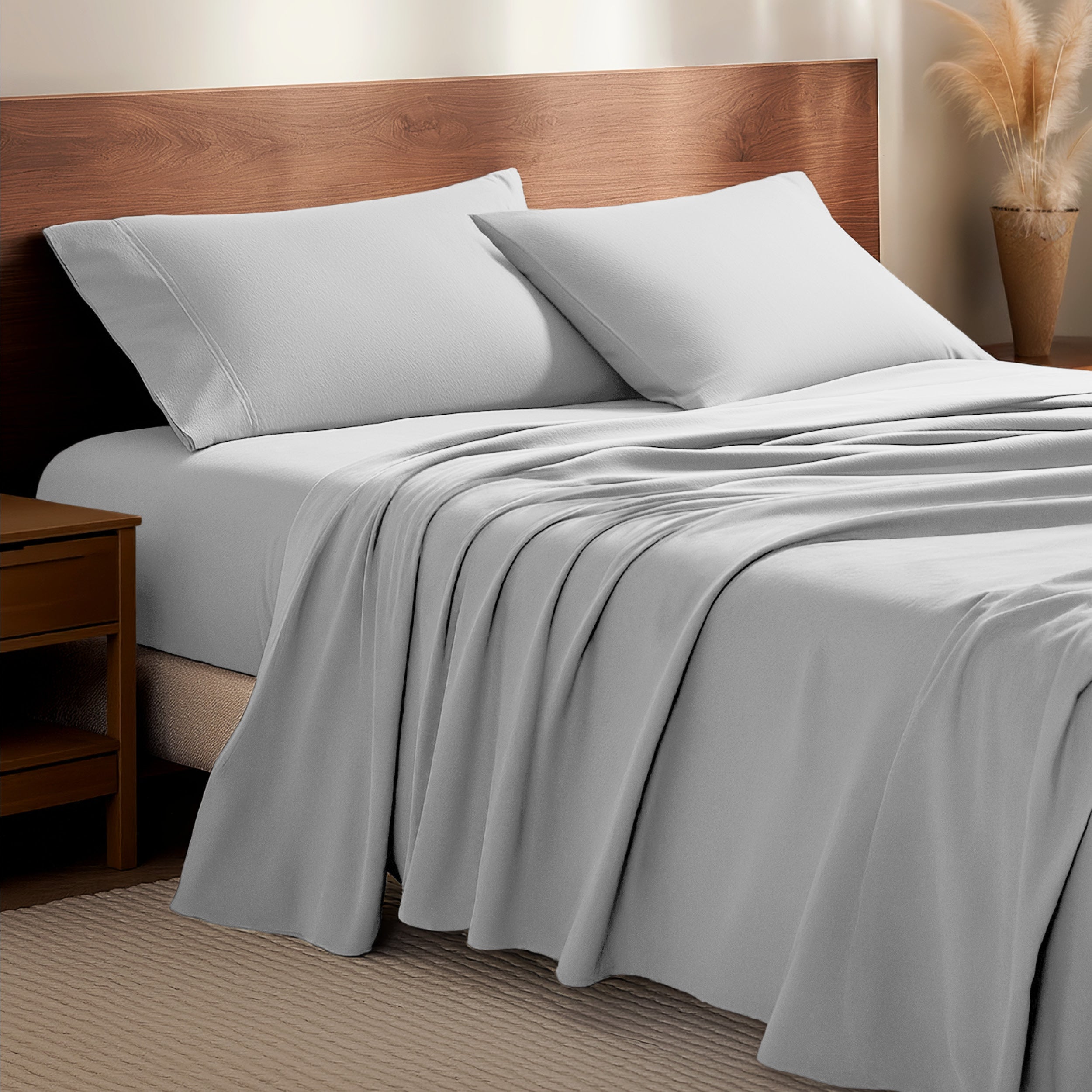 Flannel bedding set on a bed with a wooden headboard and side table