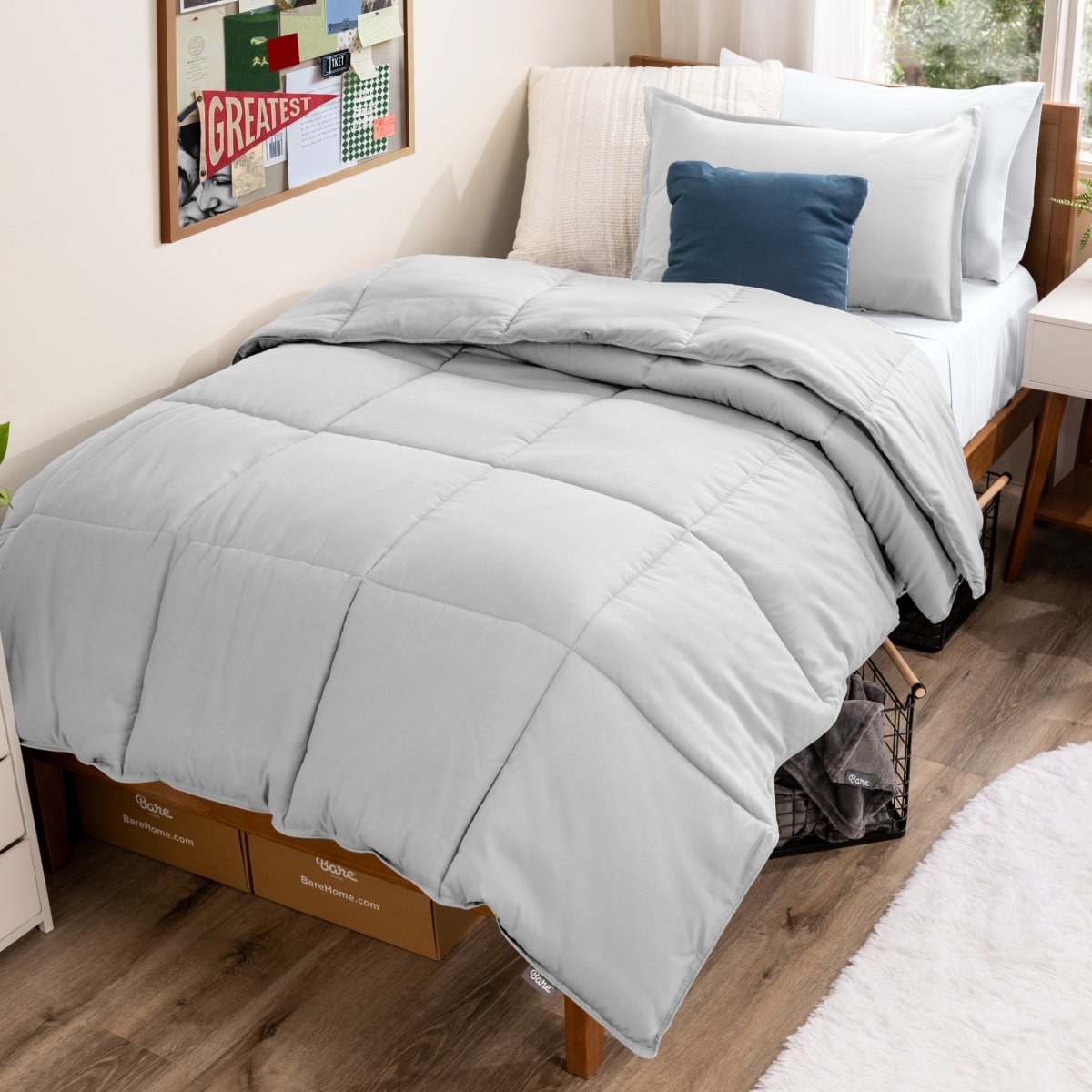 Bed with comforter and pillows in a dorm room