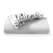 A fitted sheet folded neatly with the all around elastic showing