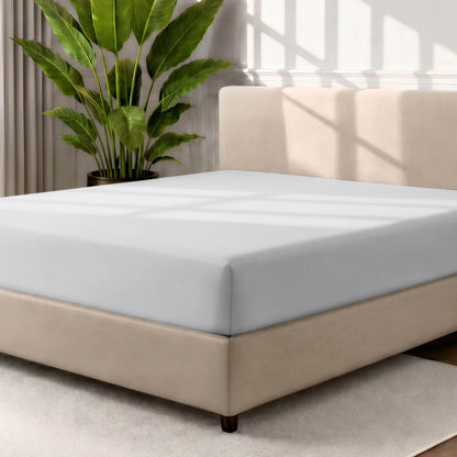 Ultra soft fitted sheet on a mattress with the sun shining into the bedroom