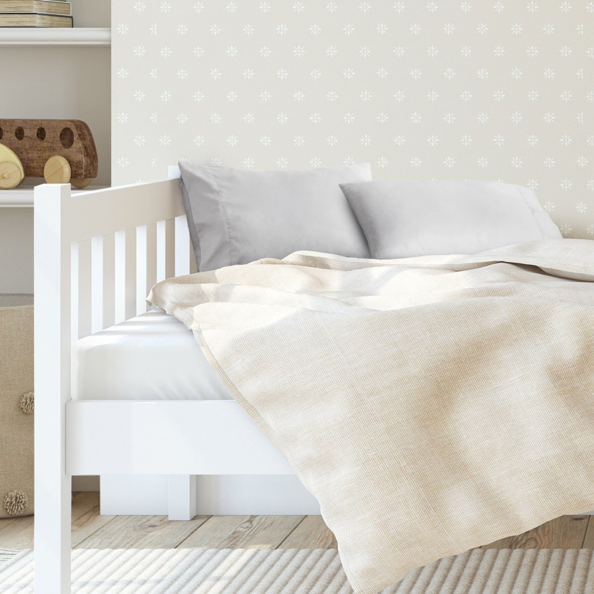 A toddler's bed with 2 microfiber pillowcases on pillows