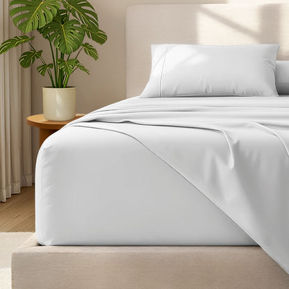 Bed with microfiber bedding and wooden headboard in a bedroom setting