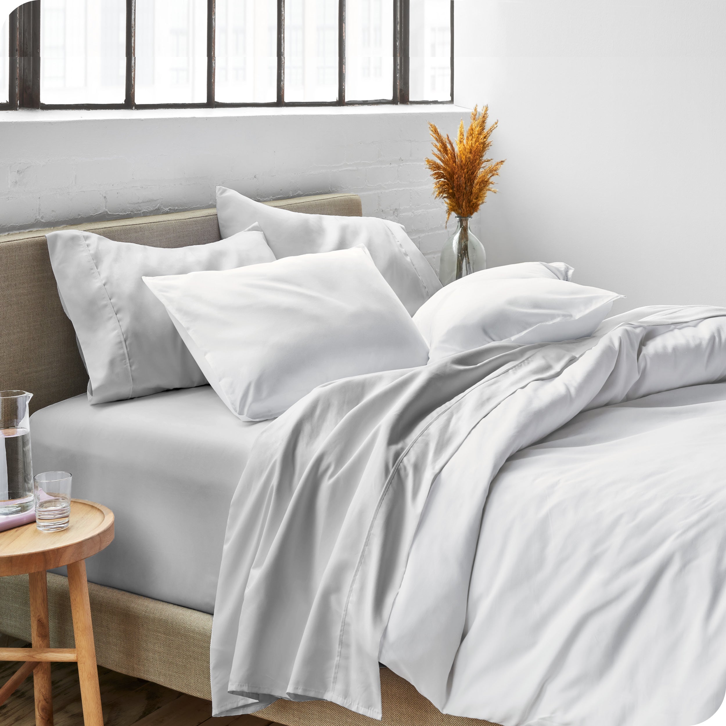 Sheets and a duvet cover on a bed in a bright bedroom
