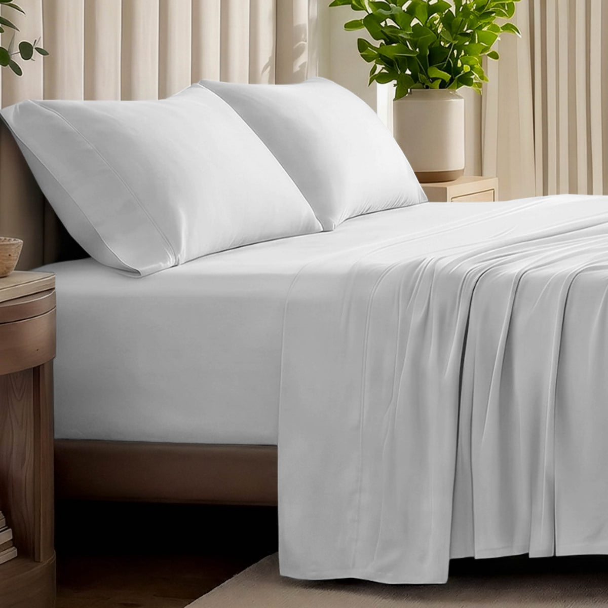 Organic jersey bed sheets and pillows on a bed with a wicker headboard.