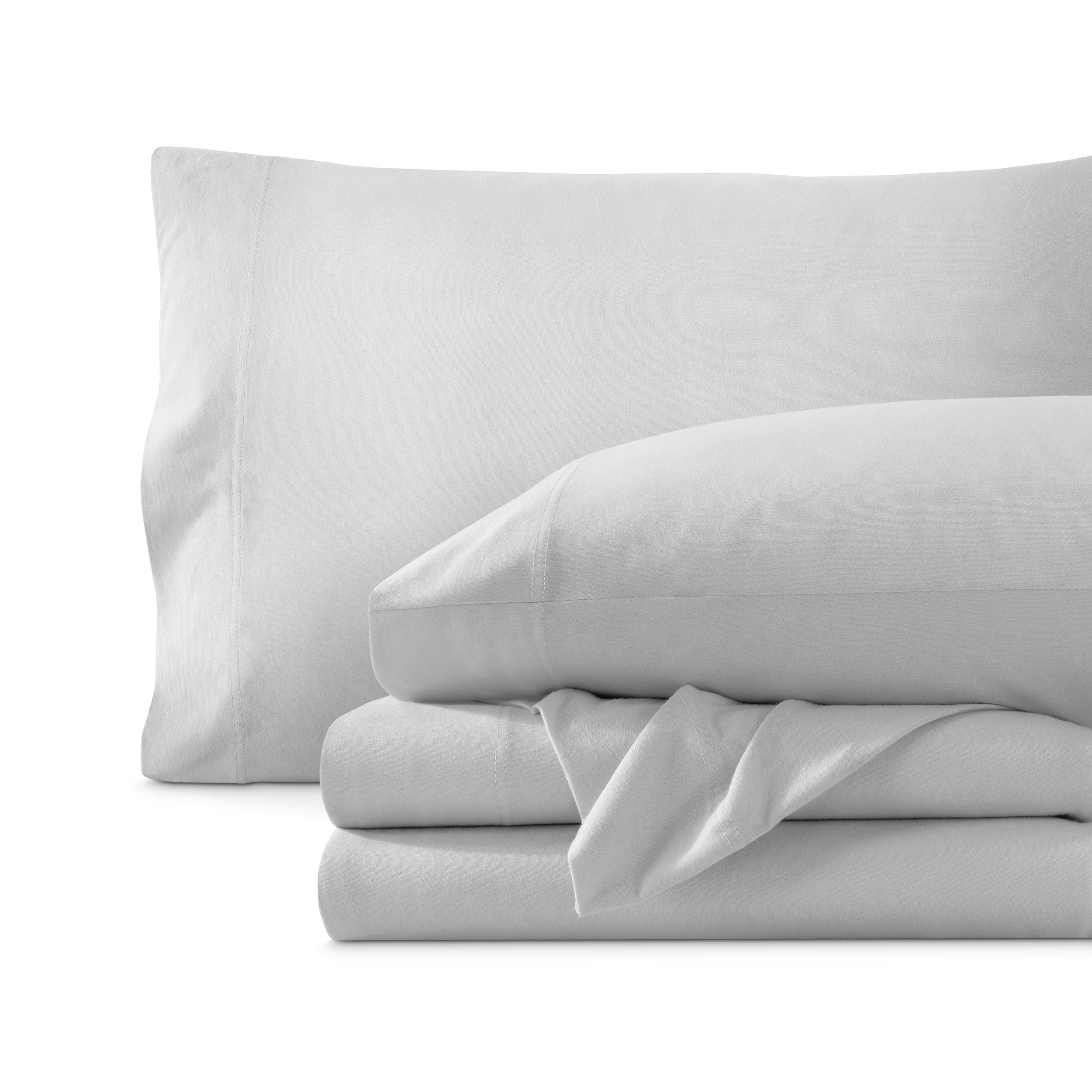 Set of organic cotton jersey sheets on a white background