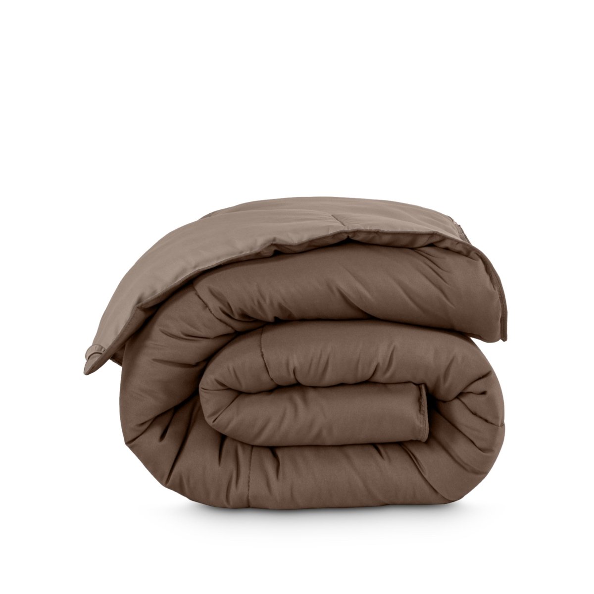 Folded reversible comforter on a white background