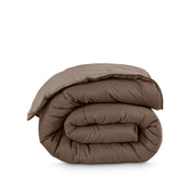 Folded reversible comforter on a white background