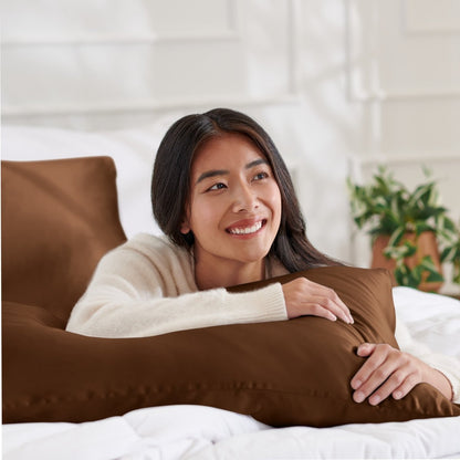Woman lying on abed with a silk pillowcase