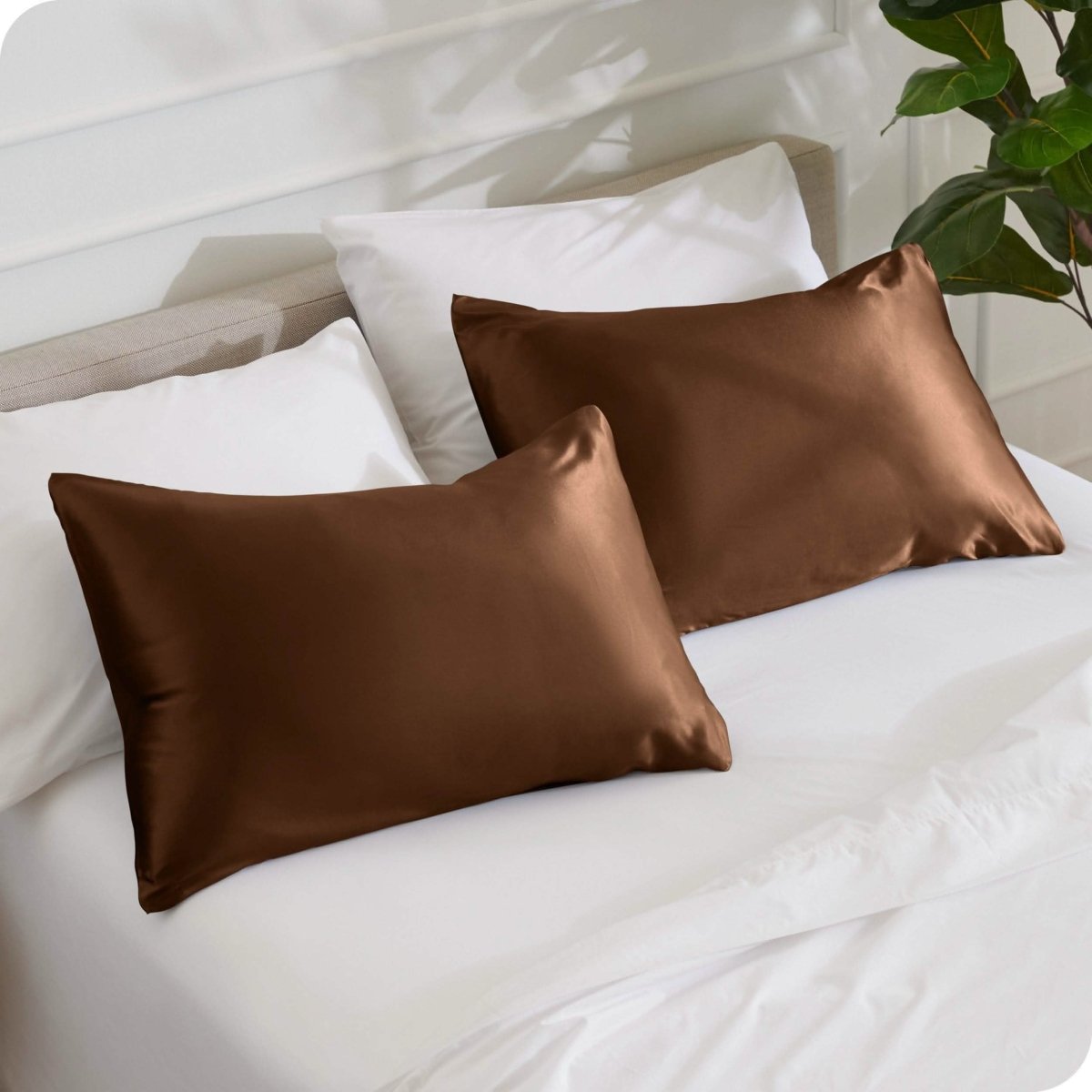 2 mulberry silk pillowcases on pillows set on a bed