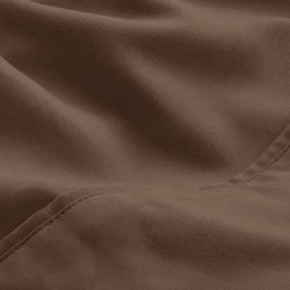 A close-up of microfiber fabric with soft folds and a visible stitched seam.