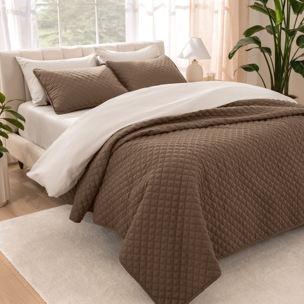 Bedroom showing coverlet set laying on the bed with the quilt folded over on itself