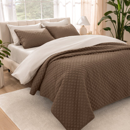Bedroom showing coverlet set laying on the bed with the quilt folded over on itself