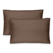 Two cocoa pillow shams on pillows standing up with one behind the other