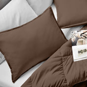 Microfiber pillow sham set on a bed with a magazine on top of the comforter.