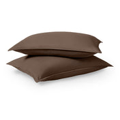 Two pillows stacked on a white background