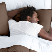 Man sleeping with his head resting on a pillow sham