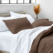Close up of pillow shams on a bed
