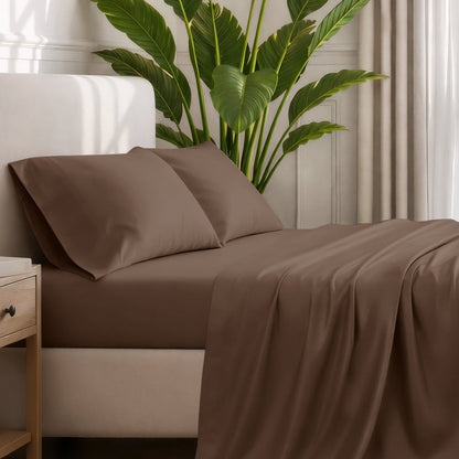Ultra-soft sheets and pillowcases on a bed with a plant in the background