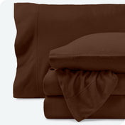 Fleece sheets folded neatly and stacked with pillows inside the pillowcases