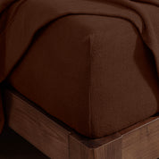 Corner of a mattress with a fitted sheet on it