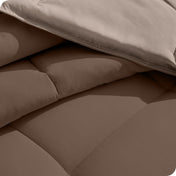 Close up of the reversible comforter showing the box stitching and the two colors