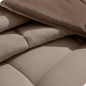 Close up of the reversible comforter showing the box stitching and the two colors