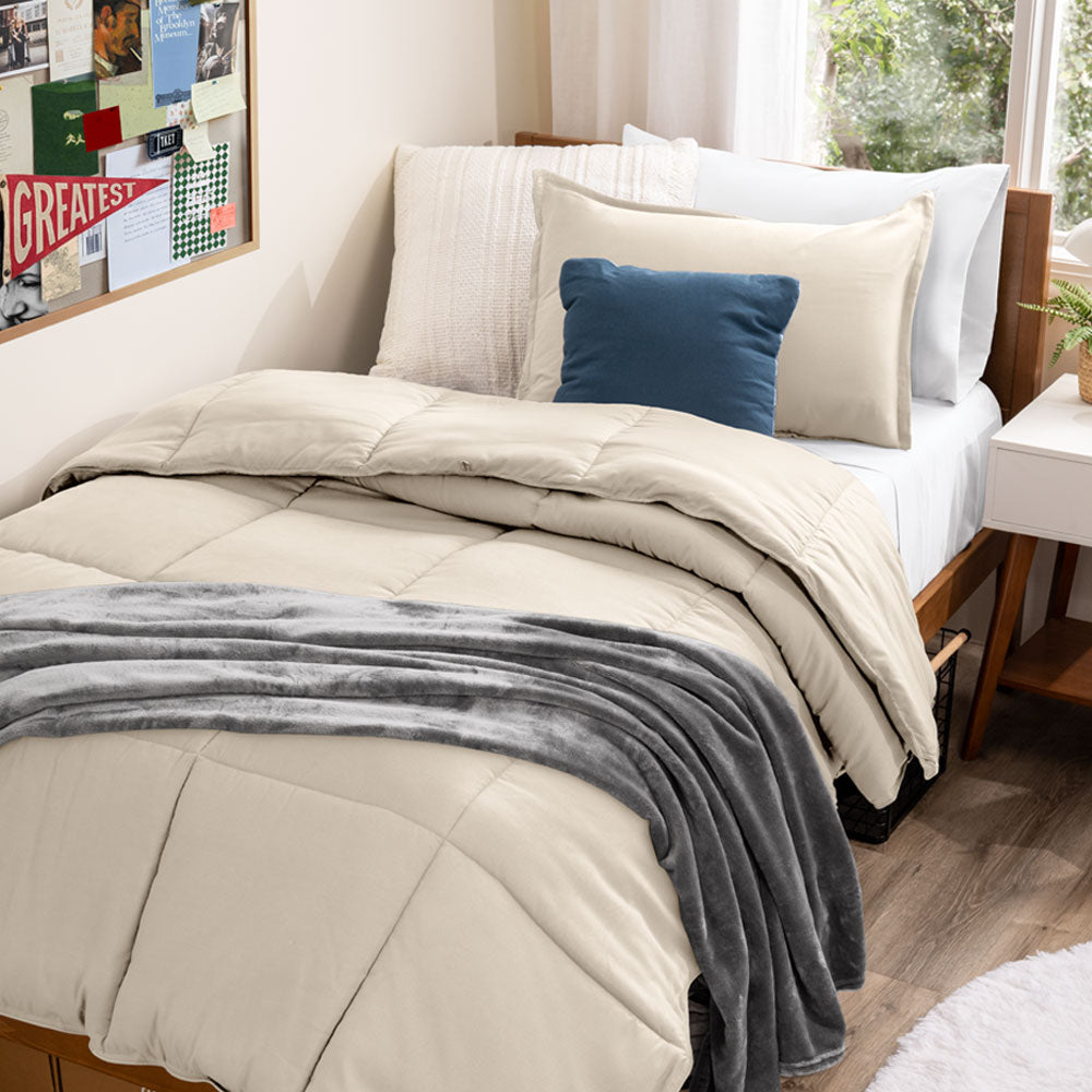 Comforter on a twin xl bed in a dorm room