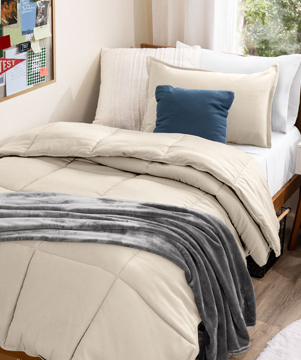 Comforter on a twin xl bed in a dorm room