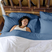 A woman sleeping in a bed made with bamboo sheets